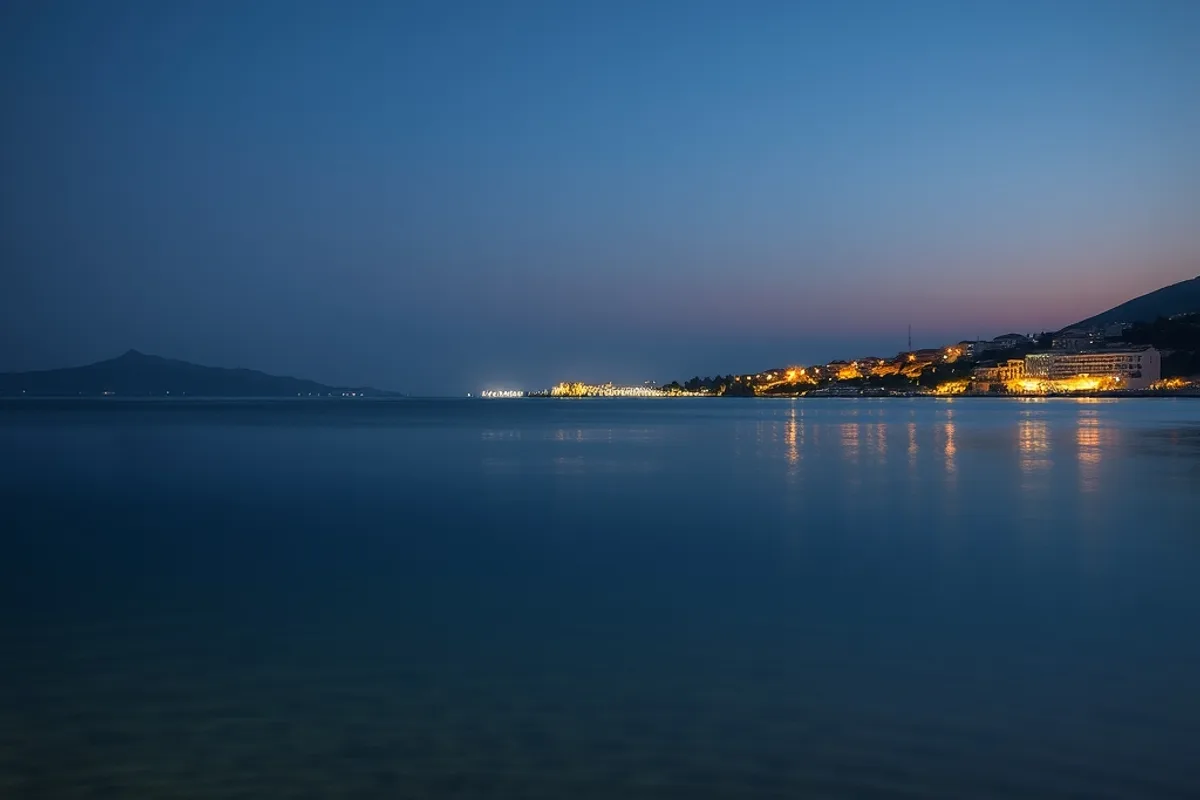 The shallow bay at dusk with the modern shoreline in the distance